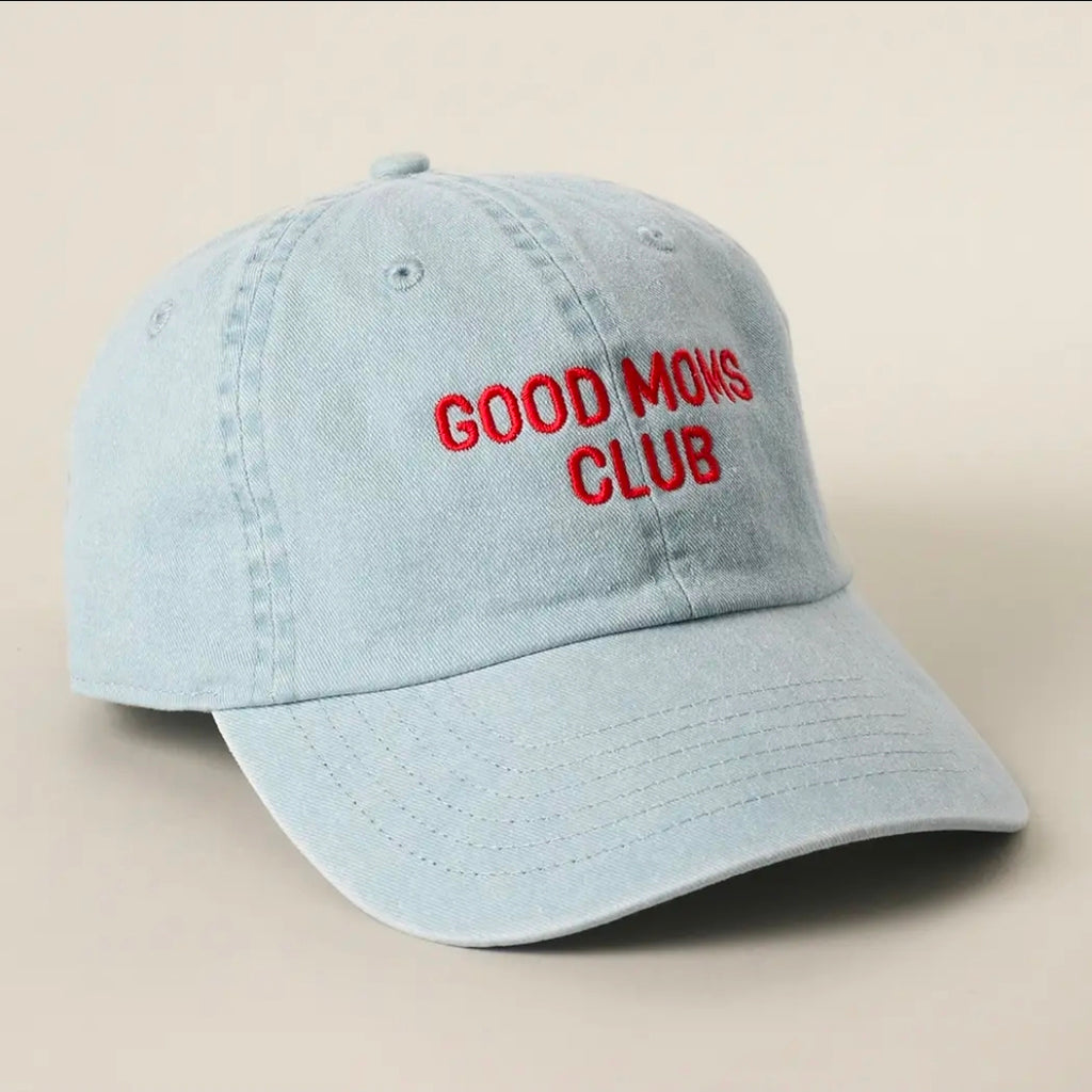 Light blue cap with 'GOOD MOMS CLUB' text in red on a beige background