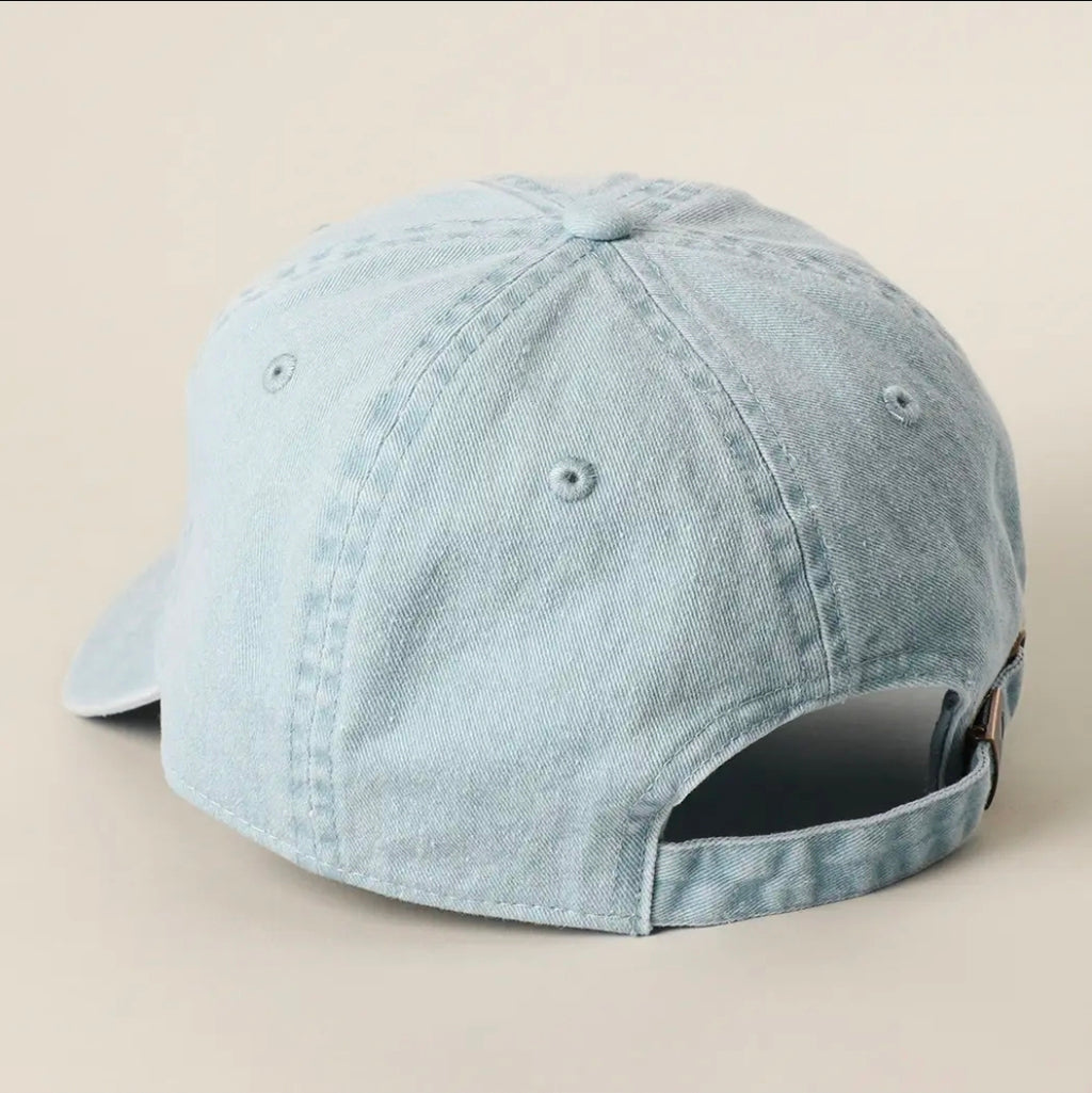 Light blue denim cap on a beige background