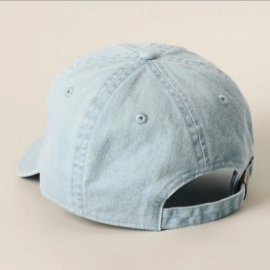 Light blue denim cap on a beige background