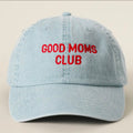 Light blue cap with 'GOOD MOMS CLUB' in red text on a beige background