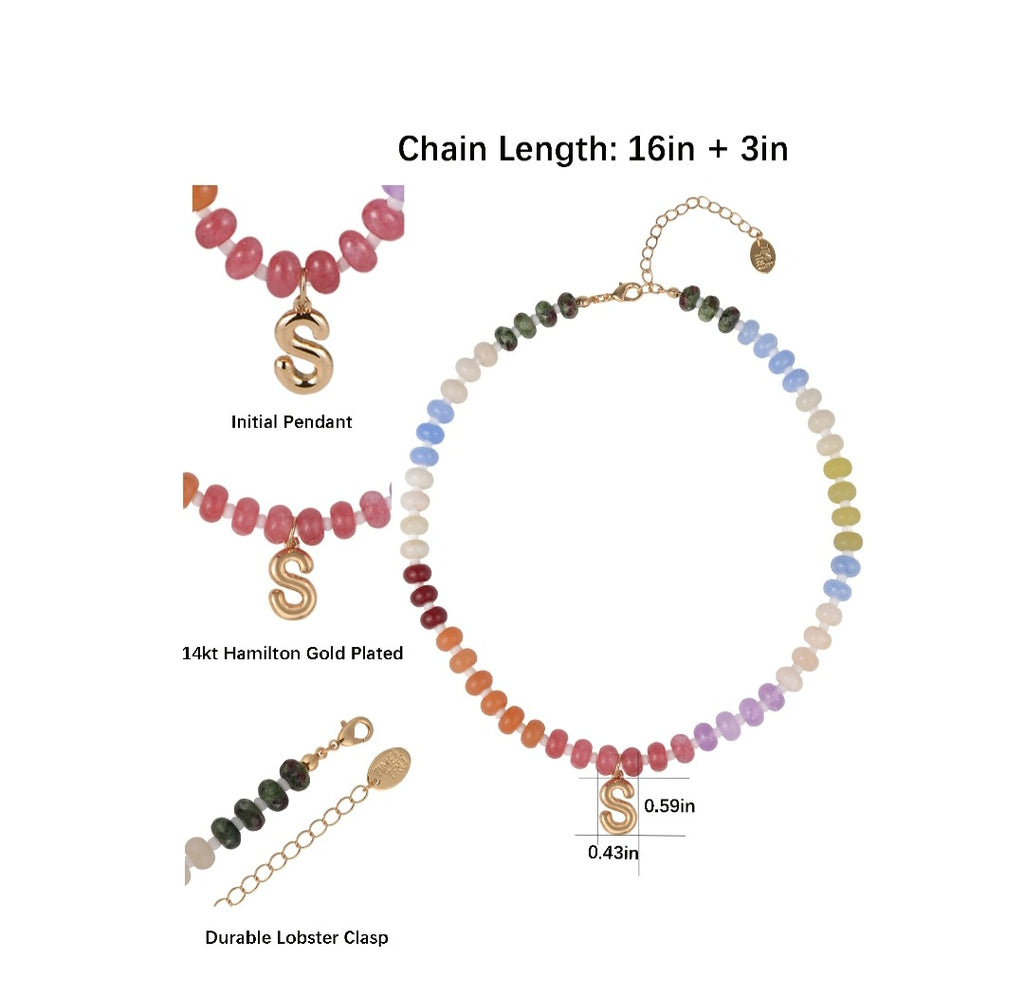 Necklace with colorful beads and gold pendants on a white background