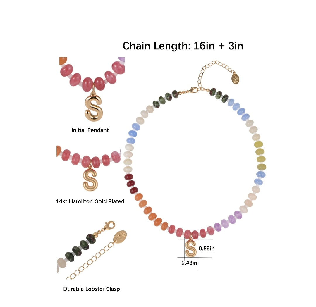 Necklace with colorful beads and gold pendants on a white background
