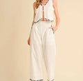 White outfit with black patterns on a beige background