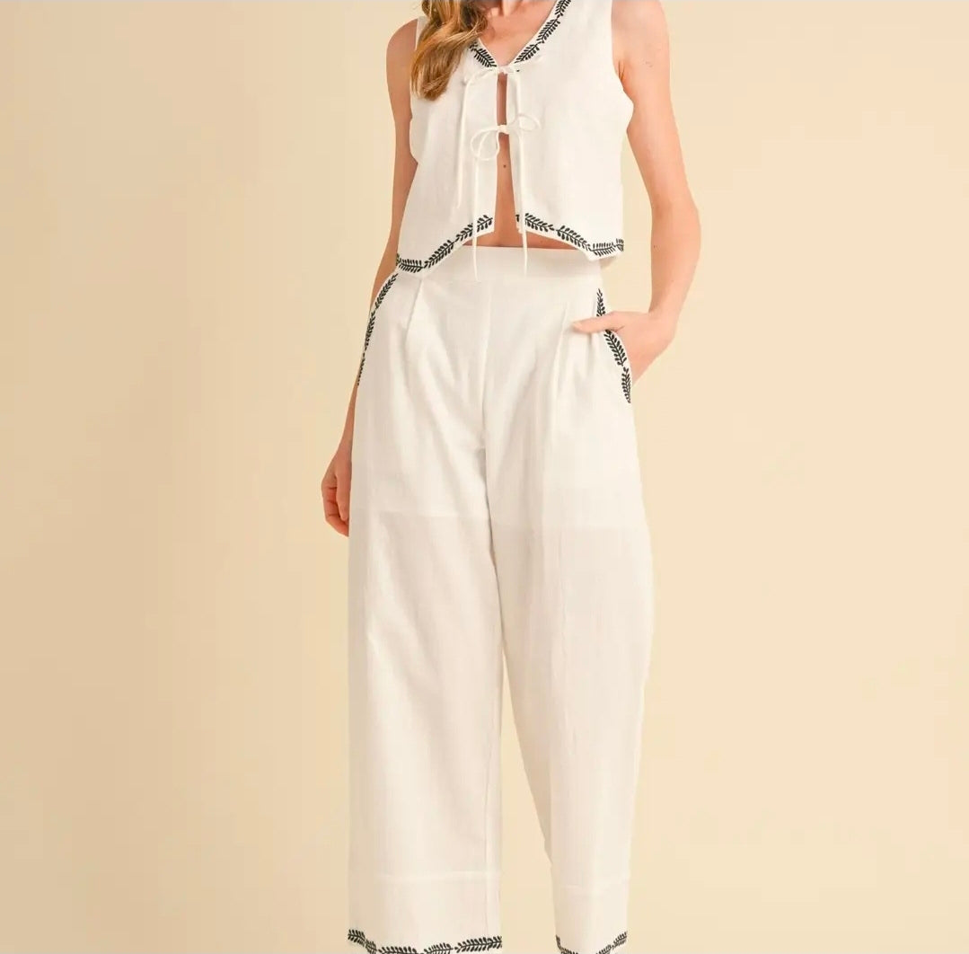 White outfit with black patterns on a beige background