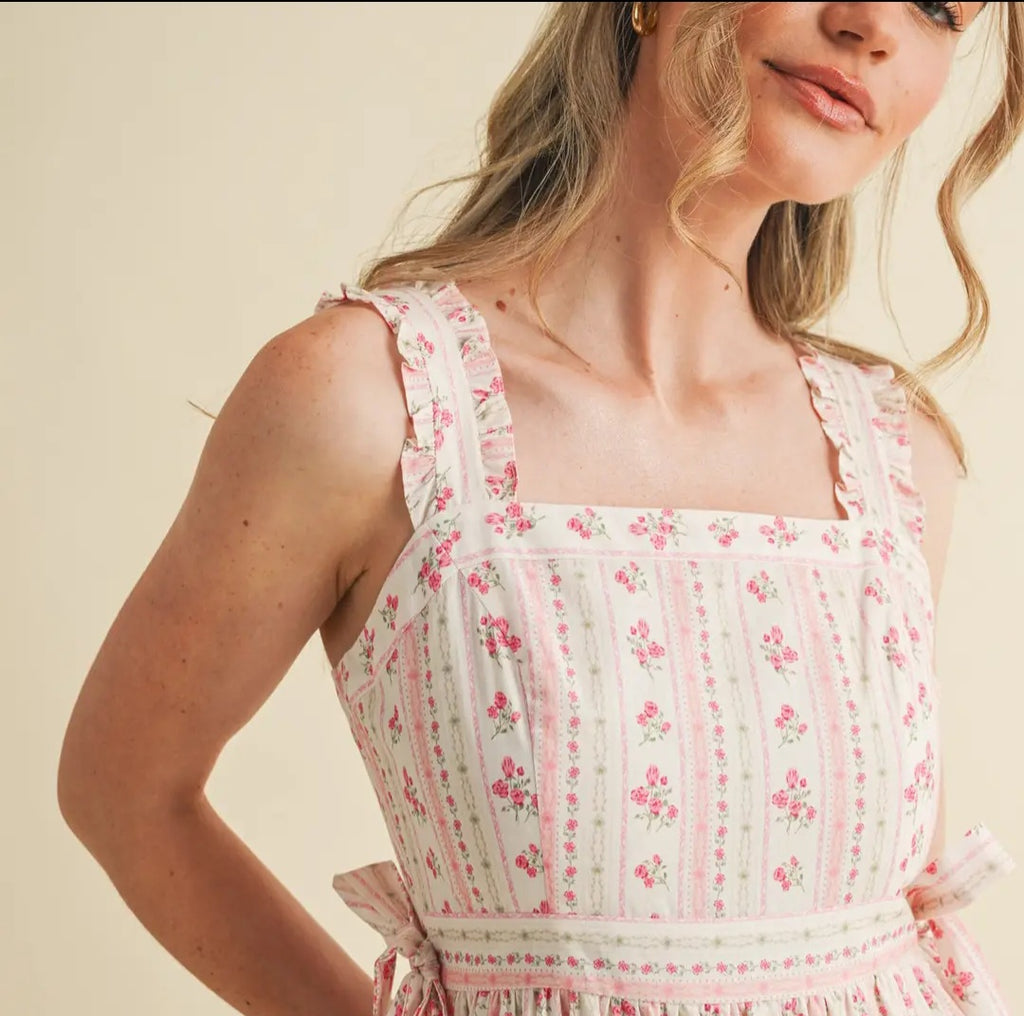 Woman wearing a floral dress with a plain background