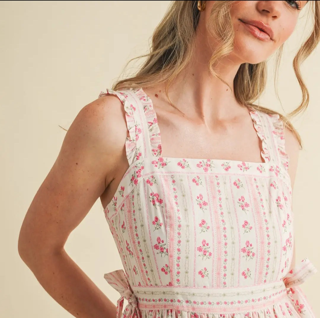 Woman wearing a floral dress with a plain background