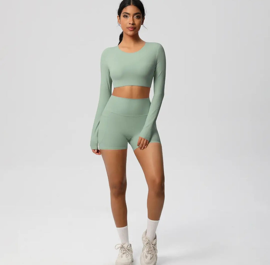 Person wearing a green athletic outfit on a plain background