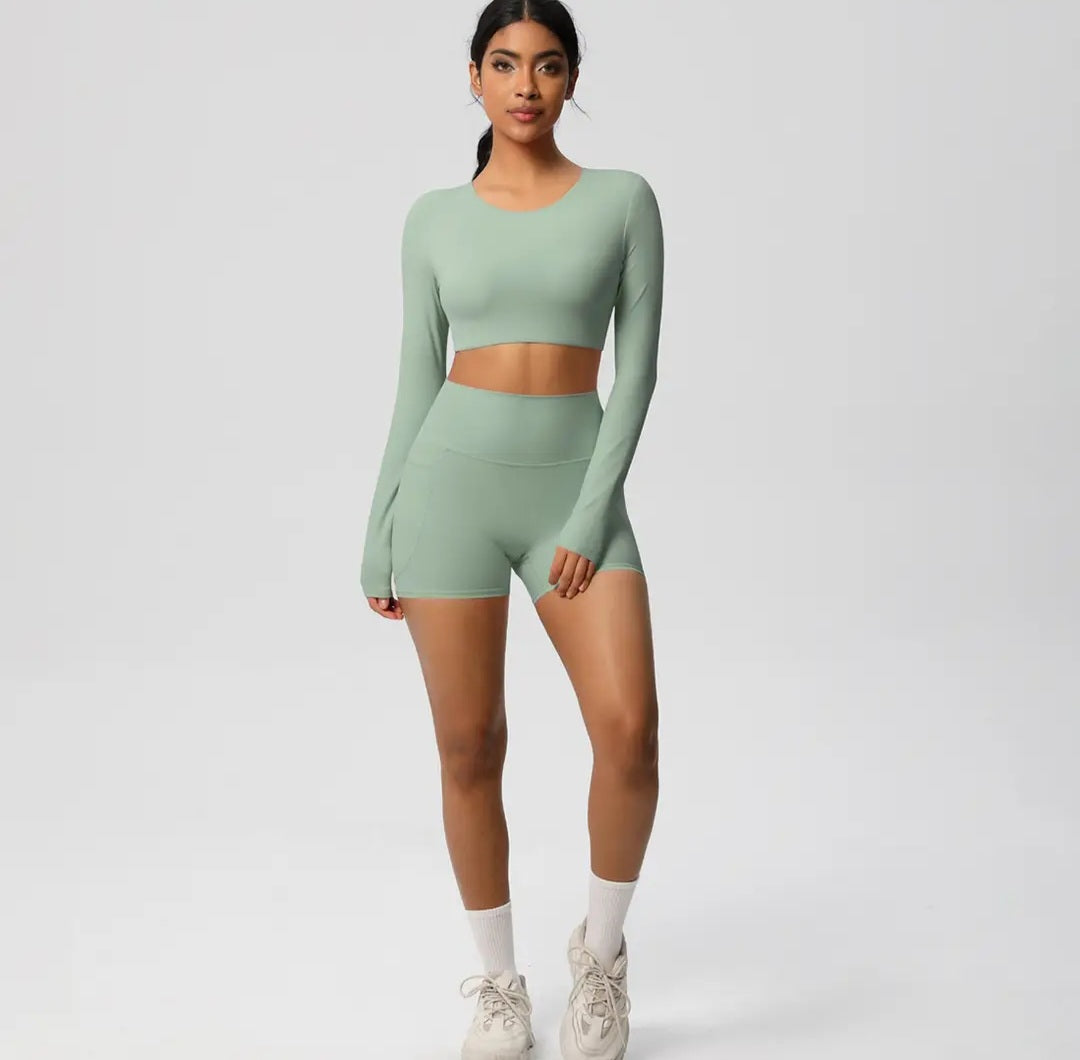 Person wearing a green athletic outfit on a plain background