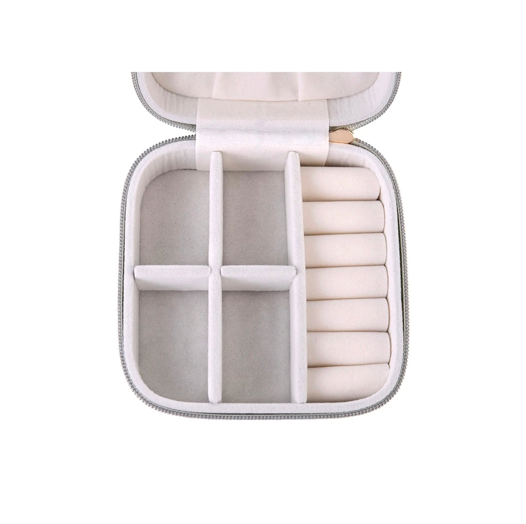 An open zippered jewelry organizer case with a light gray exterior and cream-colored interior compartments, including a ring roll on the right side, shown against a plain white background.