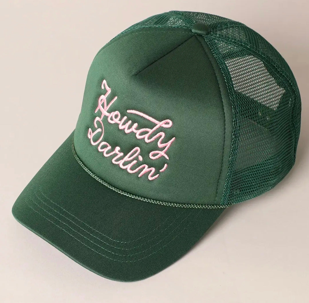 Green cap with 'Howdy Darlin' text on a beige background