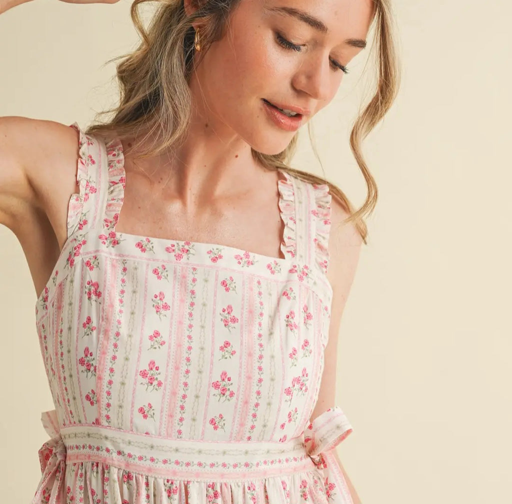 Woman wearing a floral dress against a beige background