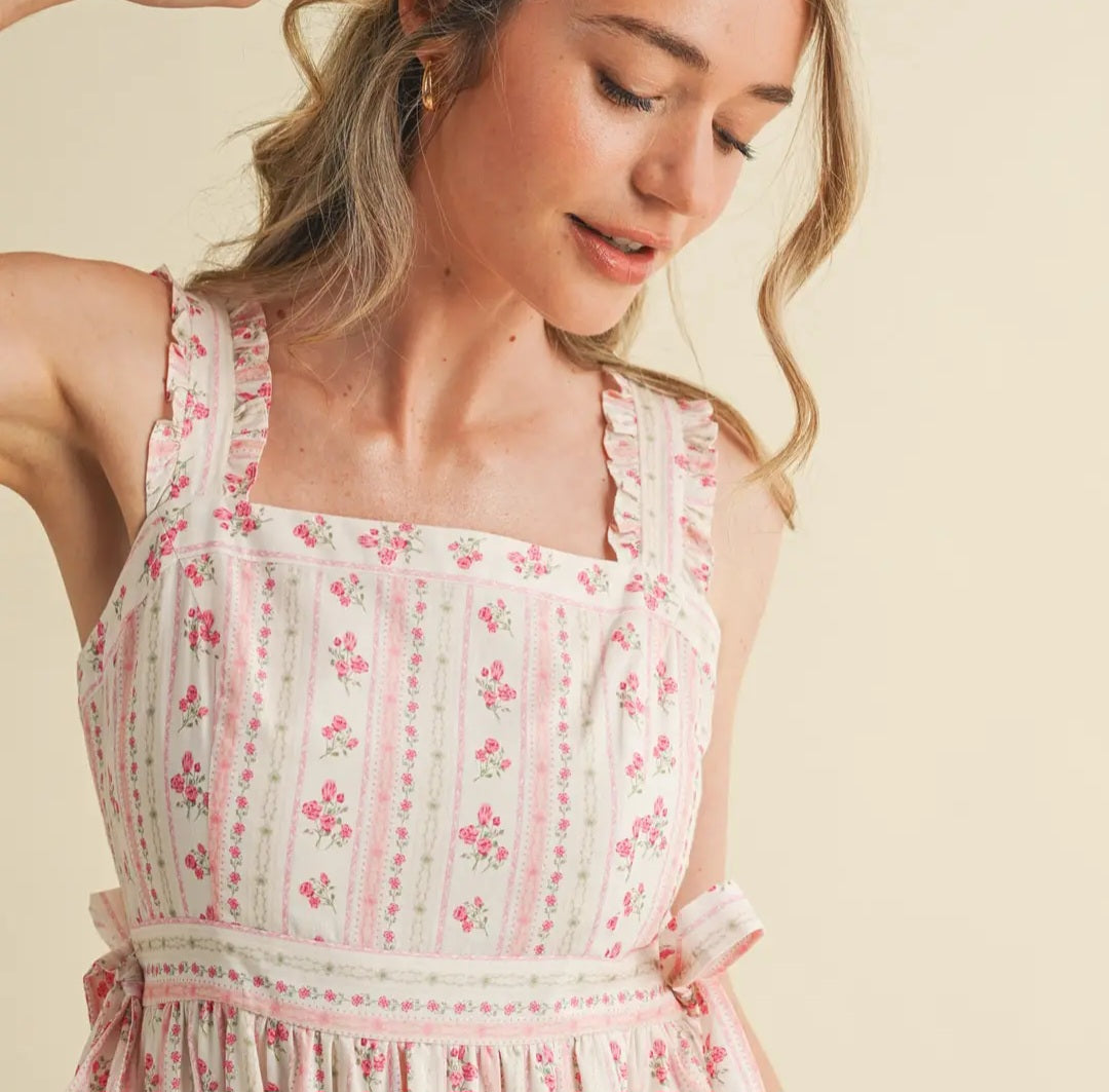 Woman wearing a floral dress against a beige background