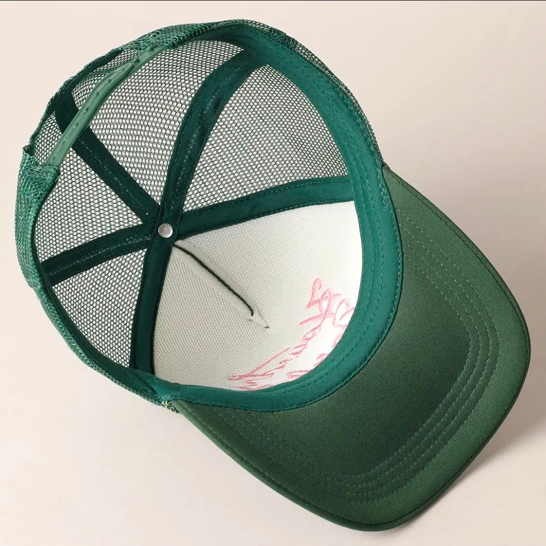 Green mesh cap on a light beige background