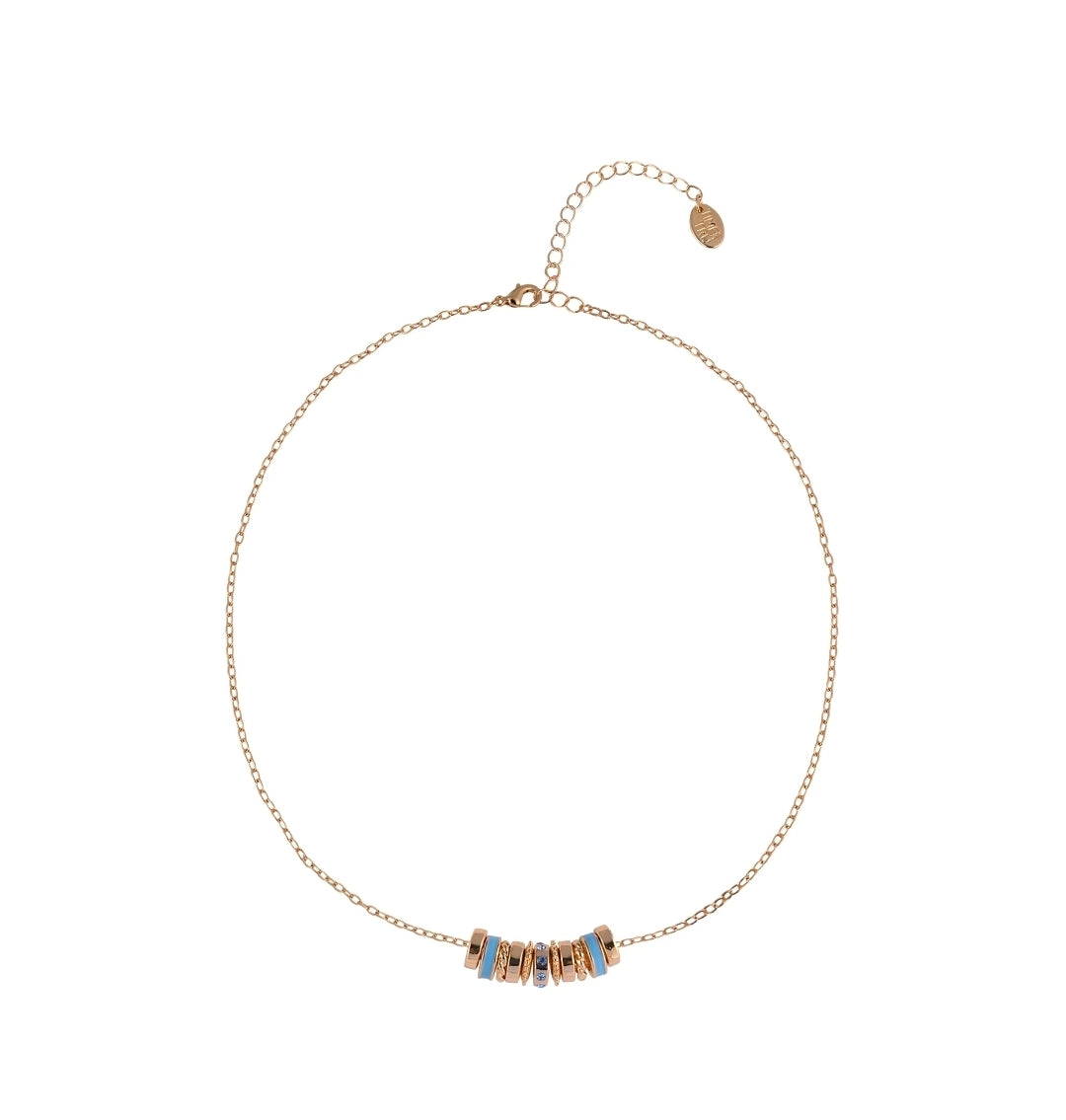 A delicate gold chain necklace with a central cluster of small metallic beads, some accented with light blue inlays, displayed on a clean white background.