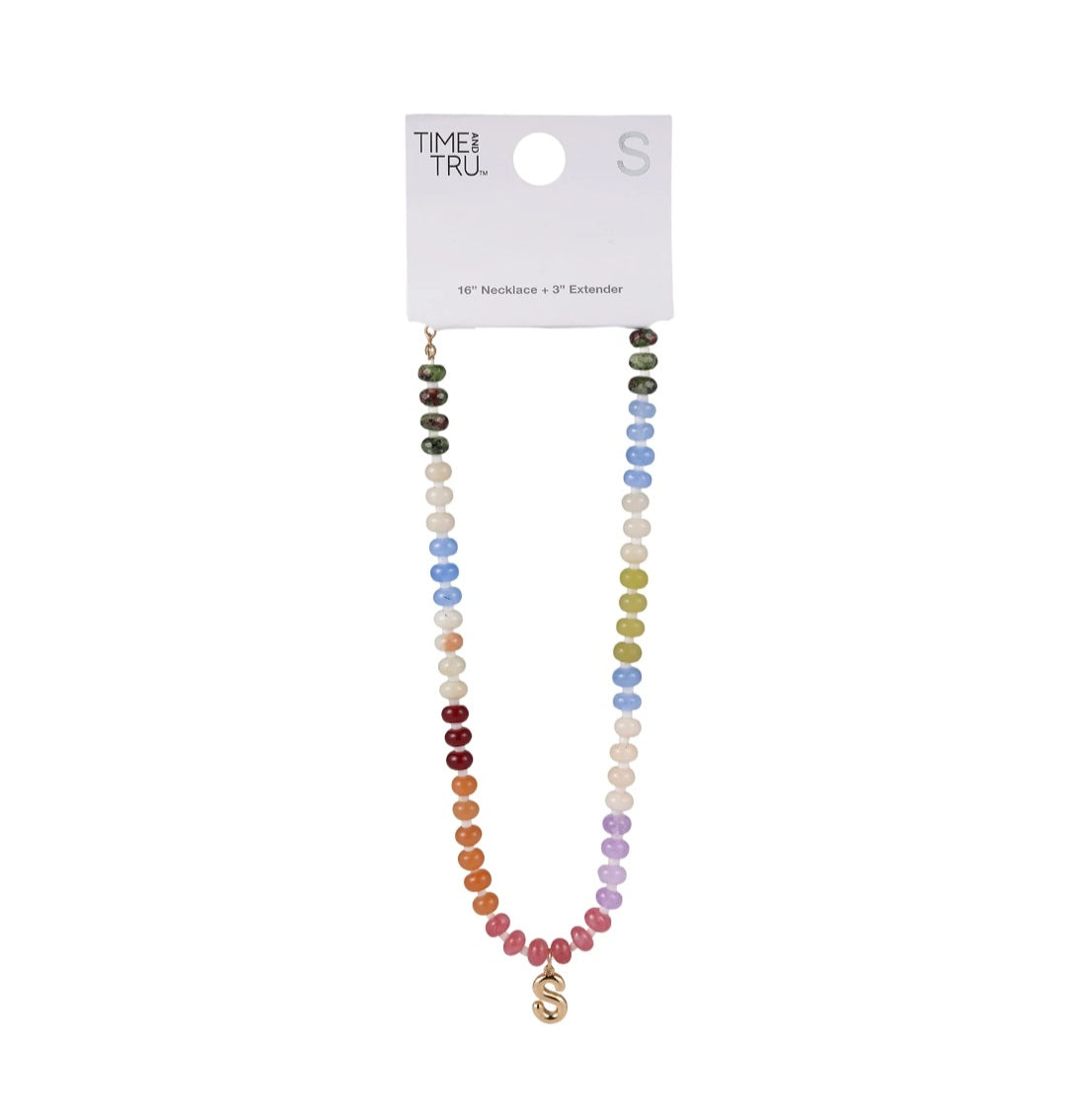 Multicolored beaded necklace on a white background with 'Time & Tru' packaging.