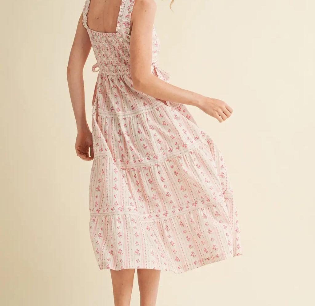 Woman wearing a floral dress on a beige background