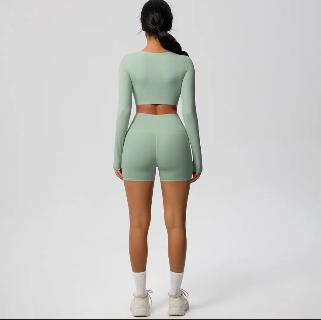 Person wearing a green athletic outfit on a white background
