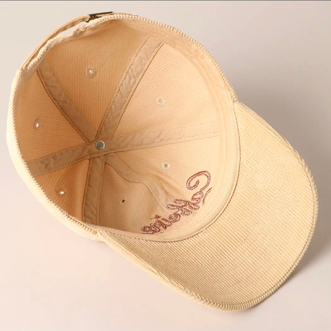 Beige cap with embroidery on a light gray background