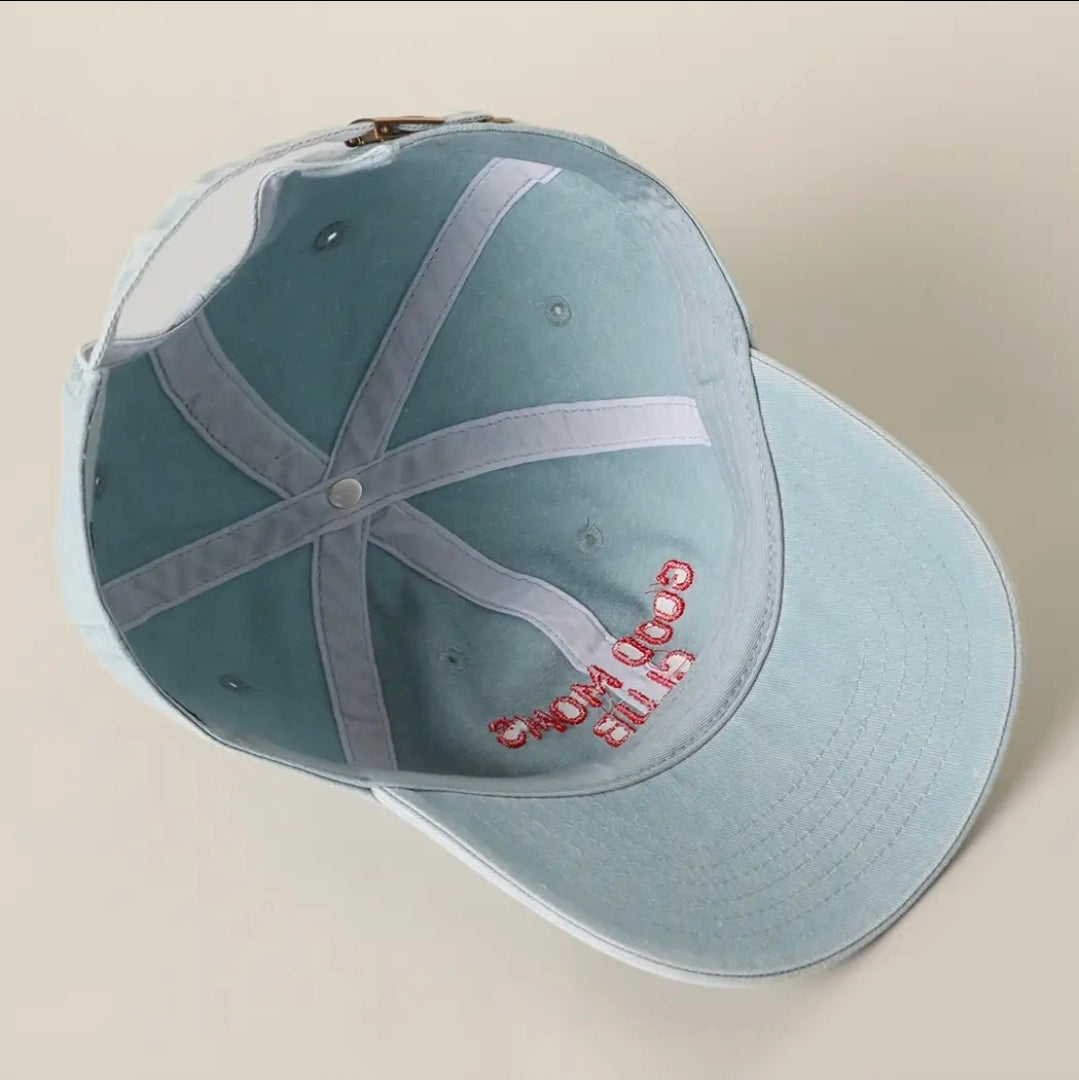 Light blue cap with red text on a beige background